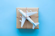 Flat lay of wrapped package with airplane model on pastel blue background. Shipping logistics transport minimal creative concept.