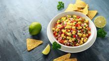 Bowl Of Fresh Mango Salsa With Nachos Chips And Herbs. Healthy Vegan, Vegetables Food.