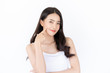 © harit - Young asian woman has smiling face and bright skin tone.Asian woman standing with isolated white background.