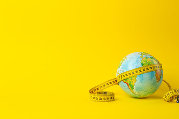 big data, research, study, distances, measurements and size concept. earth globe and measuring tape 