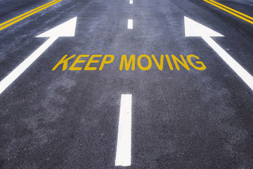 Keep moving word with yellow line marking on road surface, business success concept and challenge idea