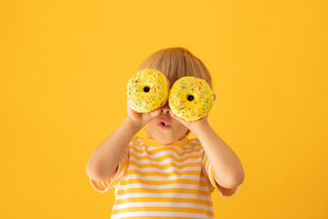 Happy child holding glazed donut