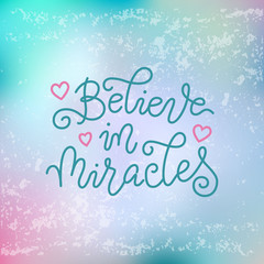 Wall Mural - Modern calligraphy lettering of Believe in miracles in blue on blue pink textured background