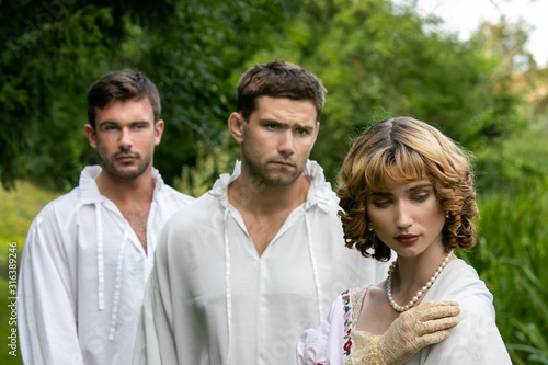 Fotomural A romantic love triangle between two men and a woman dressed in period clothing