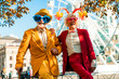 © Yakobchuk Olena - Happy older lady in clown accessories standing near her husband