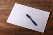 © albert - a sheet of paper with a pen on a wooden table