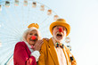 © Yakobchuk Olena - Cheerful mature couple having fun while walking in an amusement park