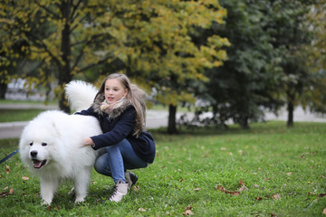 Lovely girl on a walk with a beautiful dog