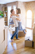 © Krakenimages.com - Young beautiful couple hugging at new home around cardboard boxes
