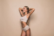 © F8  \ Suport Ukraine - Young woman in underwear on beige background. Fitness, diet, skin and body care
