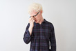 © Krakenimages.com - Young albino blond man wearing casual shirt and glasses over isolated white background tired rubbing nose and eyes feeling fatigue and headache. Stress and frustration concept.