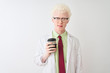 © Krakenimages.com - Albino scientist man wearing glasses drinking take away coffee over isolated white background with a confident expression on smart face thinking serious