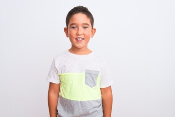 Wall Mural - Beautiful kid boy wearing casual t-shirt standing over isolated white background with a happy and cool smile on face. Lucky person.