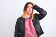 © Krakenimages.com - Young beautiful woman wearing striped shirt and jacket over isolated white background confuse and wonder about question. Uncertain with doubt, thinking with hand on head. Pensive concept.