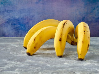 Fresh delicious bananas colored background.