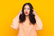 © luismolinero - Spanish Chinese woman over isolated yellow background having doubts and thinking