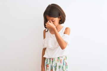 Sticker - Young beautiful child girl wearing casual dress standing over isolated white background tired rubbing nose and eyes feeling fatigue and headache. Stress and frustration concept.