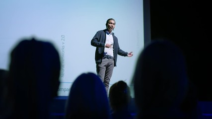 Aufkleber - Successful Male Speaker Presents Technological Product, Shows Infographics, Statistics Animation on Big Screen, Talks About Device Performance. Live Event / Device Release / Start-up Conference