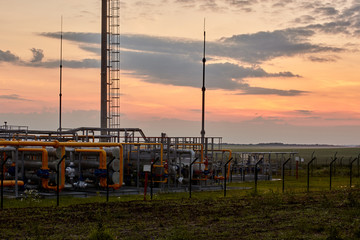 Gas industry. Pipeline system at gas processing plant illuminated by the rays of the rising sun