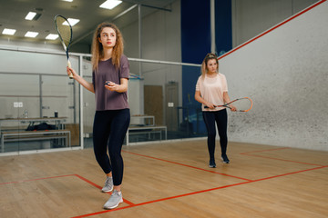 Wall Mural - Two players with squash racket playing on court