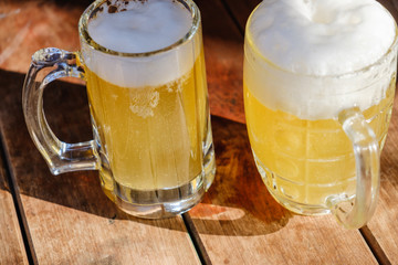 Wall Mural - Close-up two cold beers with foam and drops.