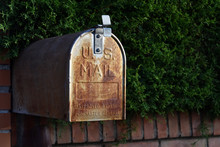 Mailbox US Mail Rusty American Design On A Street In Granada Next To A Green Hedge