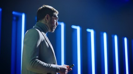 Business Conference Stage: Hardware Developer Startup CEO Presents New Product, Does Motivational Talk. Speaker does Lecture about Science, Technology, Entrepreneurship, Development, Leadership 