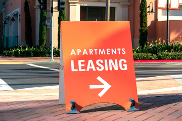 Apartments leasing sign promotes the rental property and shows direction where the rental office is located