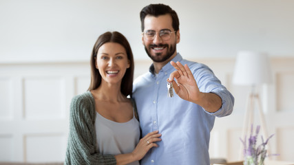 Wall Mural - Portrait of happy couple showing house keys