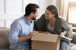 © fizkes - Excited couple unpack package with online order