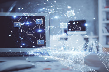 Desktop computer background in office and flying envelops hologram drawing. Multi exposure. Electronic mail concept.