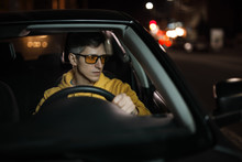 Man Driving Car In Special Yellow Eyeglasses At Night For Good Night Vision