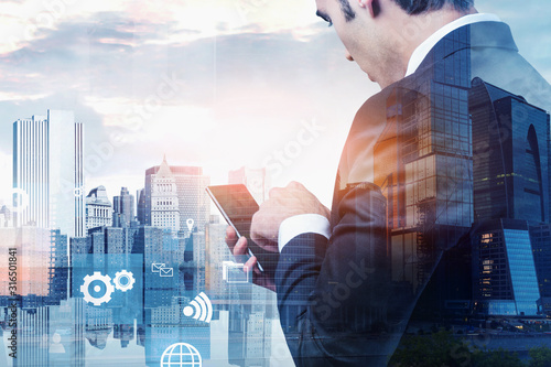Cuadros en Lienzo Man using smartphone in city, business interface