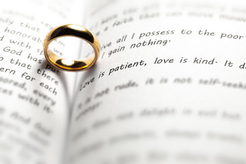 Wall Mural - Golden wedding ring on bible book