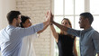 © fizkes - Happy diverse employees team giving high five, celebrating success