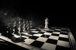 © zef art - Chess figures on a dark background with smoke and fog. Selective focus