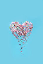 Abstract Image Of A Heart Made Of Sparkles Crumbles Into Fragments. Concept Of Disappearing Feelings