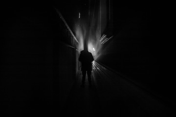 Dark corridor with cabinet doors and lights with silhouette of spooky horror person standing with different poses.