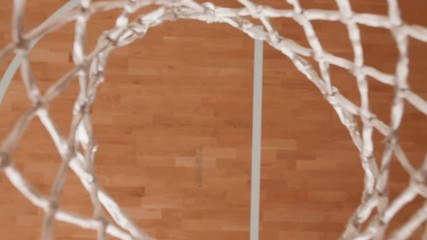 Close up shot of a basketball hoop made with a professional video crane. Basketball commercial. 4K Slow motion shot