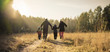 © avtk - happy family walking on country road