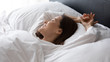 © fizkes - Close up happy beautiful woman enjoying morning, lying in bed