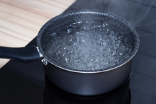 Boiling Water In Saucepan For Cooking Soup. Bowl Hot Water On Electric Stove.