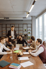 Wall Mural - serious business people hold meeting in office for discussing and speaking about business projects, ideas and strategies for future. successful confident men in elegant suits indoors