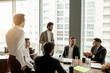 © alfa27 - coworking of young caucasian business people in office, wearing formal wear, leaders enjoy to be a part of successful business team. panoramic window in the background