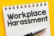 Workplace harassment text on notepad - business concept