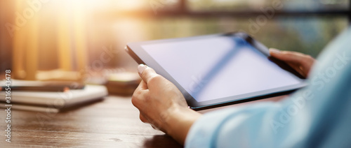 Fotomural Woman pointing on digital tablet screen, chatting in social networks, meeting website, searching internet, sending sms, using text messenger or online banking