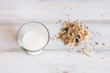 Top view of Muesli cereals and glass of milk on a wooden table. Healthy and natural breakfast