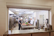 © Andrey - cook preparing dinner in a restaurant kitchen.