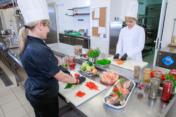 Wall Mural - cook preparing dinner in a restaurant kitchen.