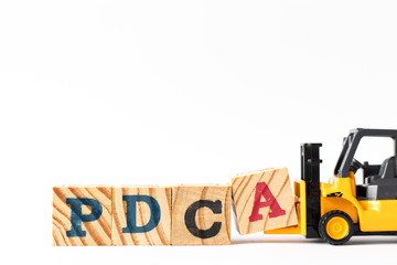 Wall Mural - Toy forklift hold wood letter block a to complete word PDCA (Plan, Do, Check, Act) on white background